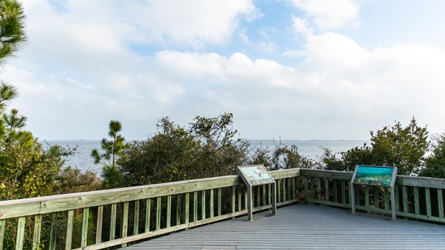 An overlook with waysides and a cloudy blue sky.