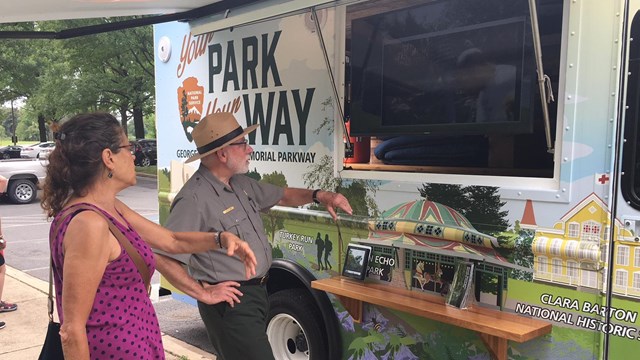 Park Ranger shows the Mobile Visitor Center to visitor.