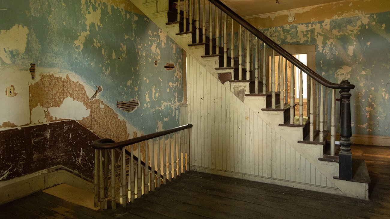 Hallway with two stairwells, one leading down and one leading up