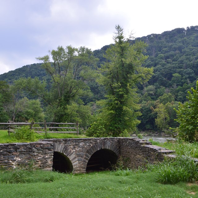 Two mountains in the background. Old stone structure from a mill in the foreground.