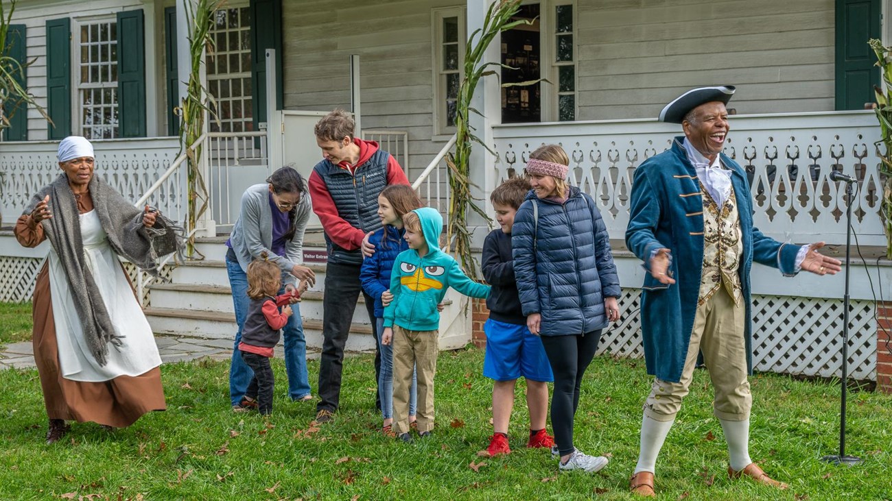 A group of visitors participate in a program during Harvest Day.