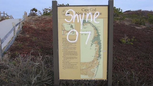 Vandalized wayside exhibit at Cape Cod.