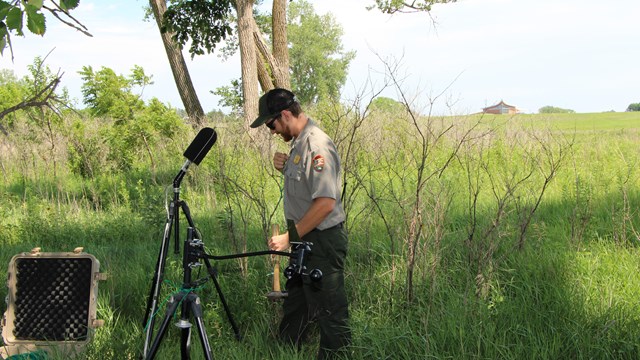 Ranger setting up soundscape equipment