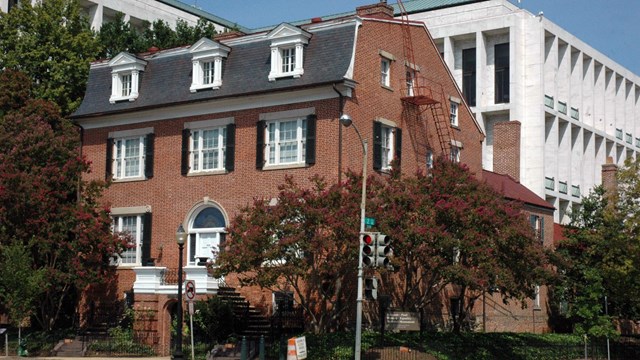 Three-story brick house on a street corner