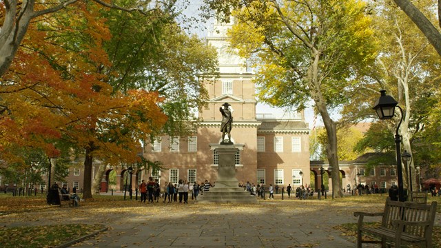 Color photo of Independence Square, an outdoor area with a red brick building in the backgrround.