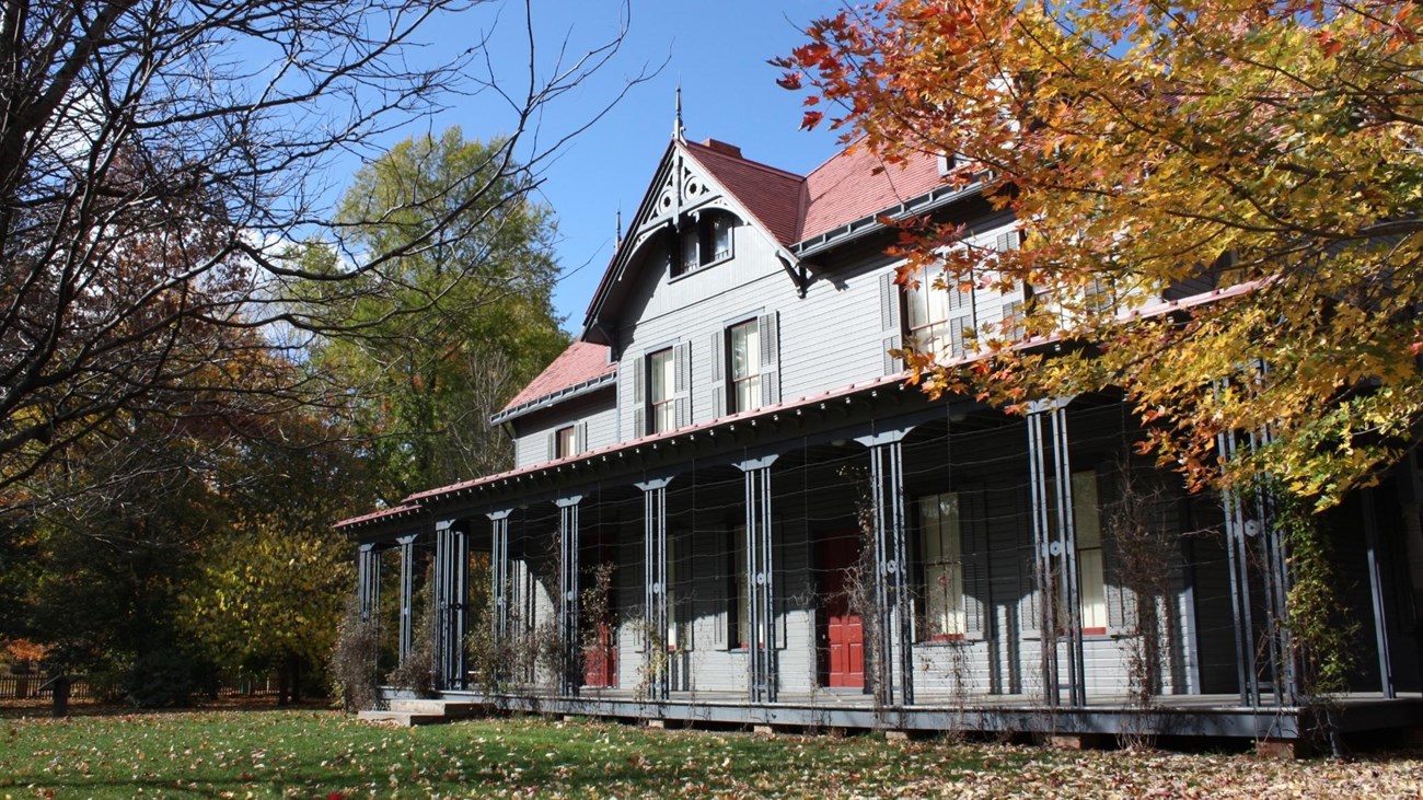 Back of Garfield house with  trees in background.