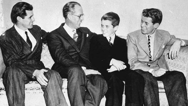 Black-and-white photo of Joe Jr., Joe Sr., RFK, and JFK