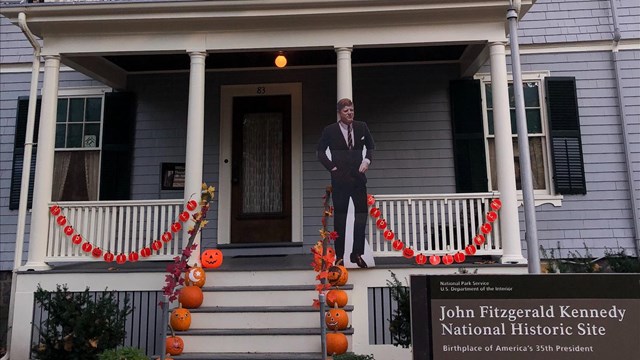 Photo of the front porch of the JFK birthplace decorated for Halloween.