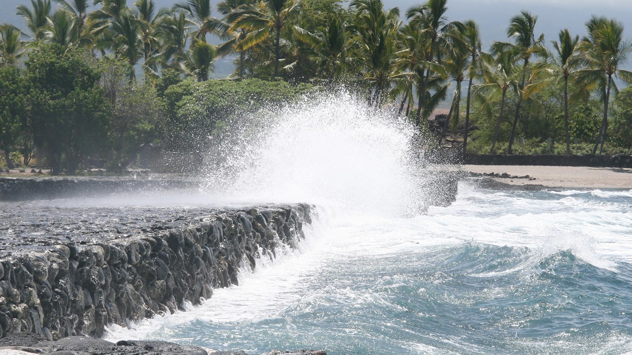 Kaloko kuapā (sea wall) with wave crashing