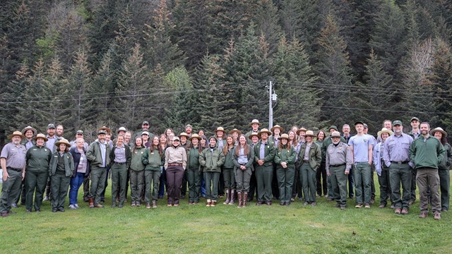 Rows of dozens of park employees in various uniforms.