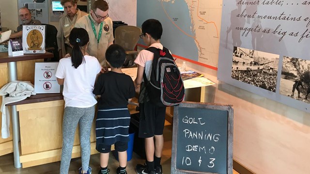 rangers talk to children at an information desk