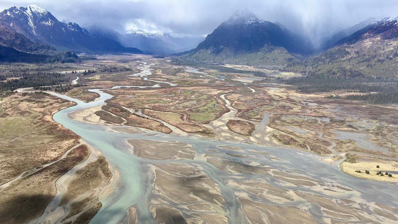 Landscape of mountains and braided river channels.