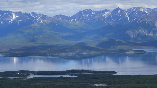 mountains reflect in Lake Clark's wateer