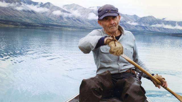 Dick Proenneke standing in front of his cabin