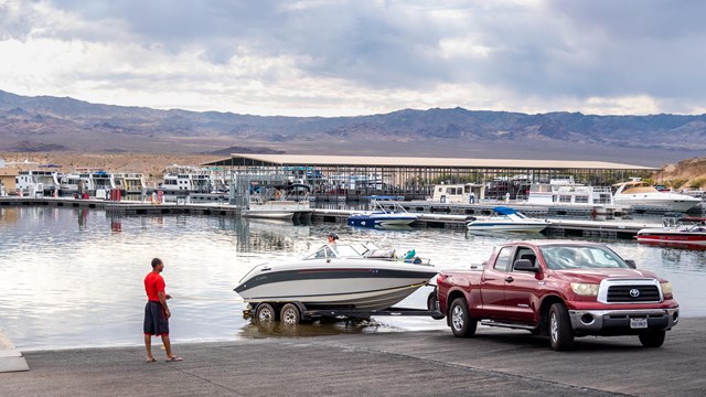 A truck launches a boat into a body of water