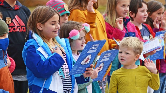 blue activity booklet and badge 