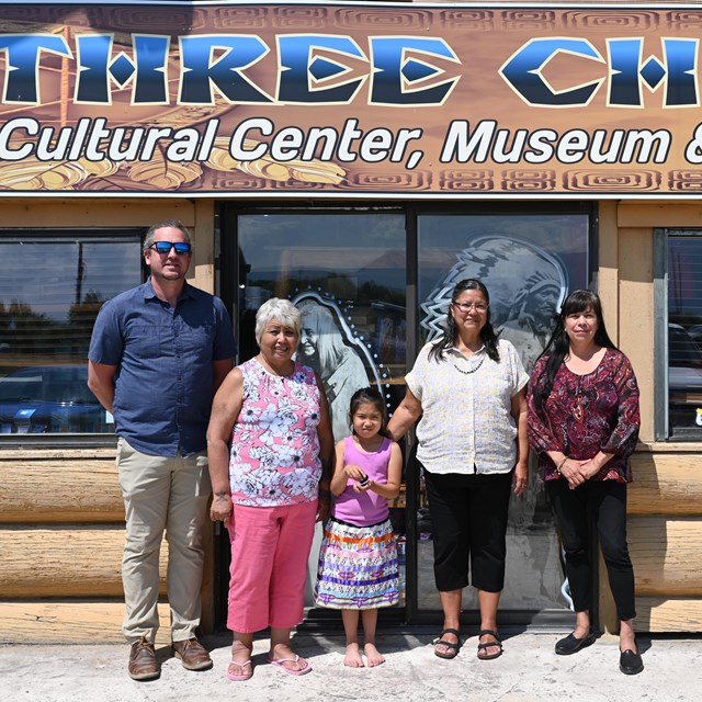 five people in front of a museum