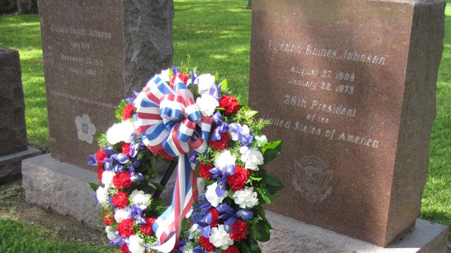 A wreath stands in front of President Johnson's headstone in the family cemetery.