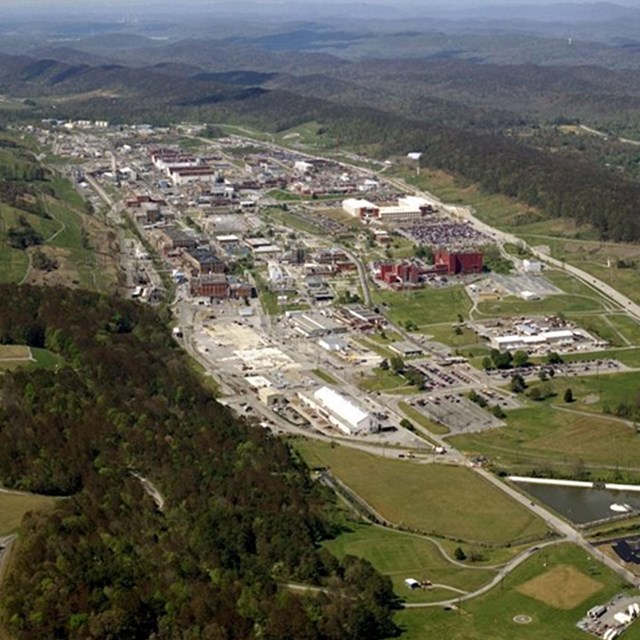 Aerial photo of large number of buildings in between two ridges