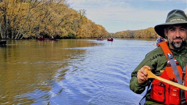 Two paddlers float down the river in their canoe.