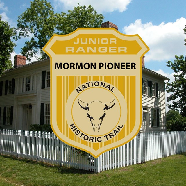 A picture of a junior ranger badge on top of an image of a big white, two story historical home 