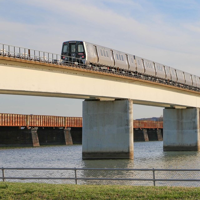 Metro train on a bridge over a river