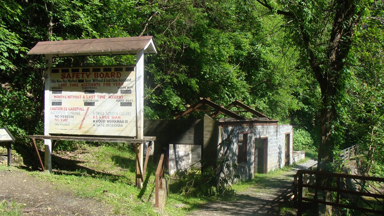 mine safety board and ruins of an old building in the woods