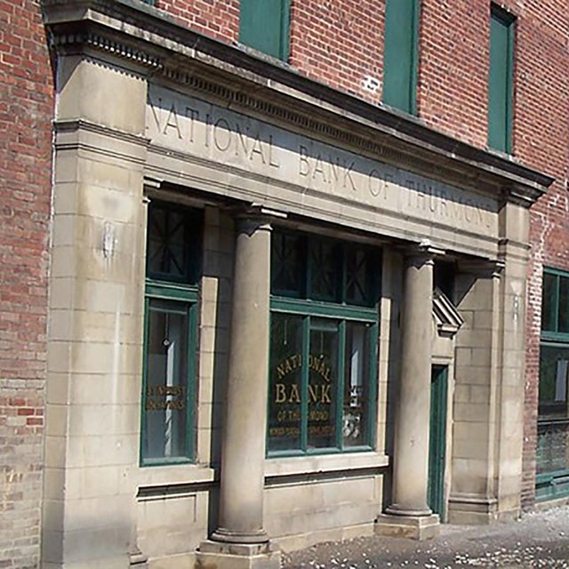 A row of brick buildings next to railroad tracks