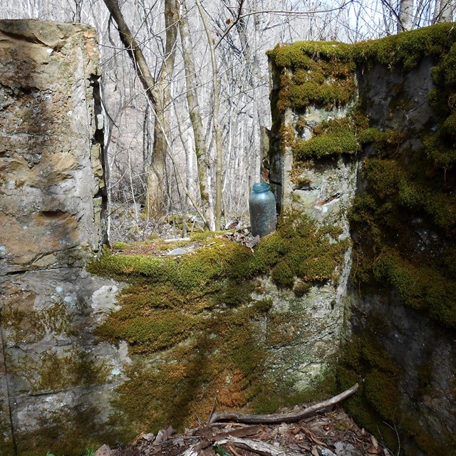 Old stone wall ruins of a building in the forest