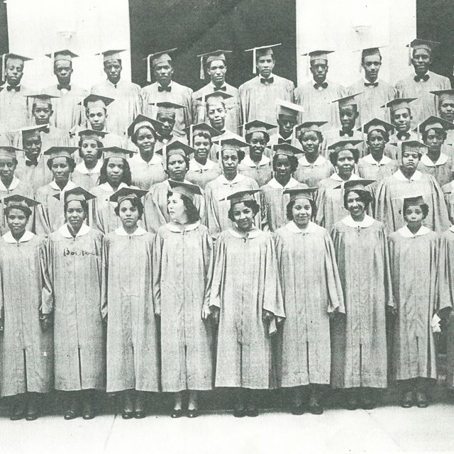 black and white photo of high school students on school steps