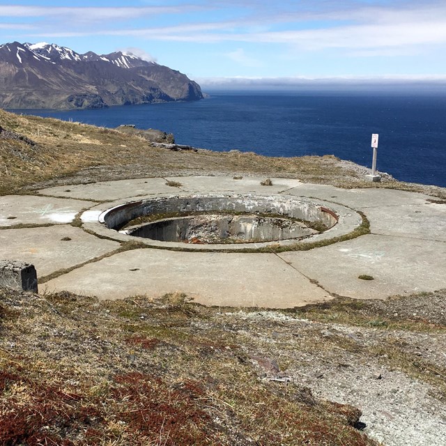 A 360-degree gun mount on top of a sea cliff.