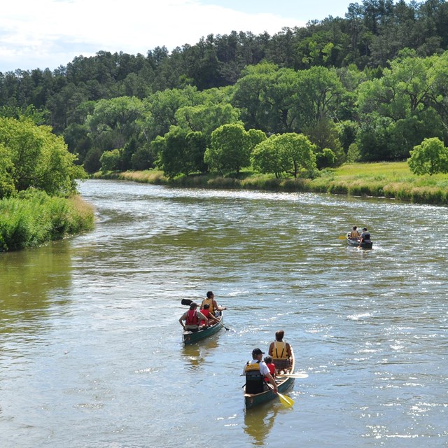 Three canoes at a distance on the river