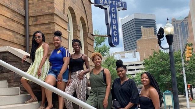 Line of people on the steps of a historic church