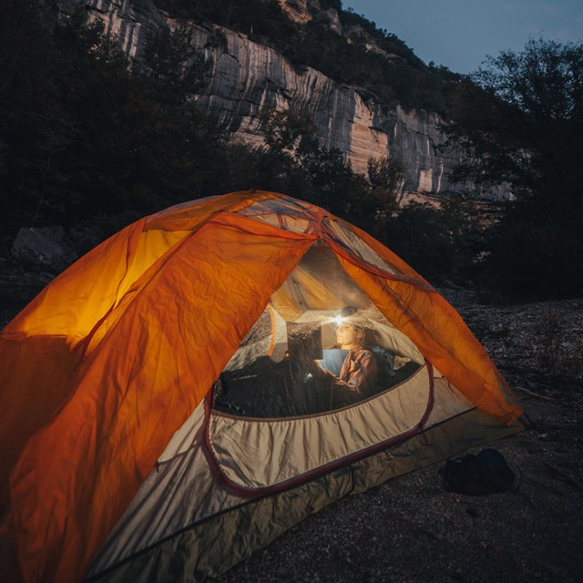 Tent with glow of headlamp.