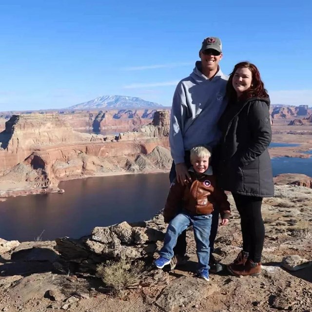 Family standing above a large canyon