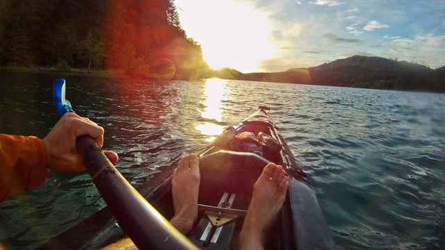 Bow of a kayak on a lake.