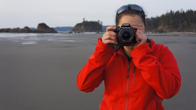 Photographer taking a photo at the beach.