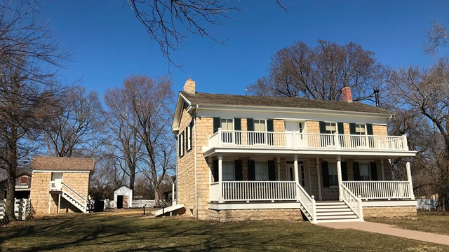 A historic two-story wooden home with a large front porch.