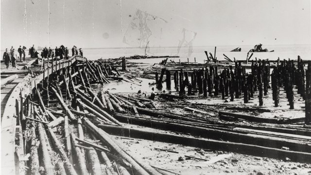 A historic photo of the disaster, showing piles of wood from the shattered pier.