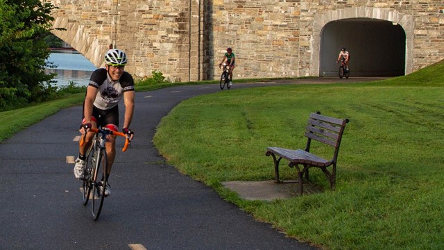 person riding a bike on a paved trail