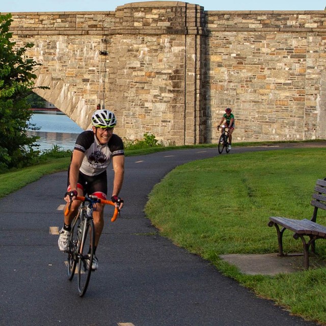 person riding a bike on a paved trail
