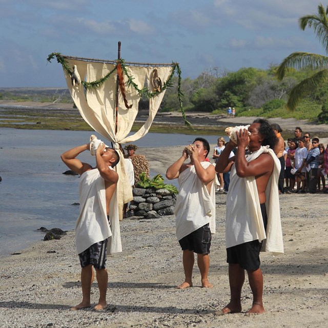 Blowing conch shells to start the Makahiki Ceremony, Kaloko-Honokōhau National Historical Park