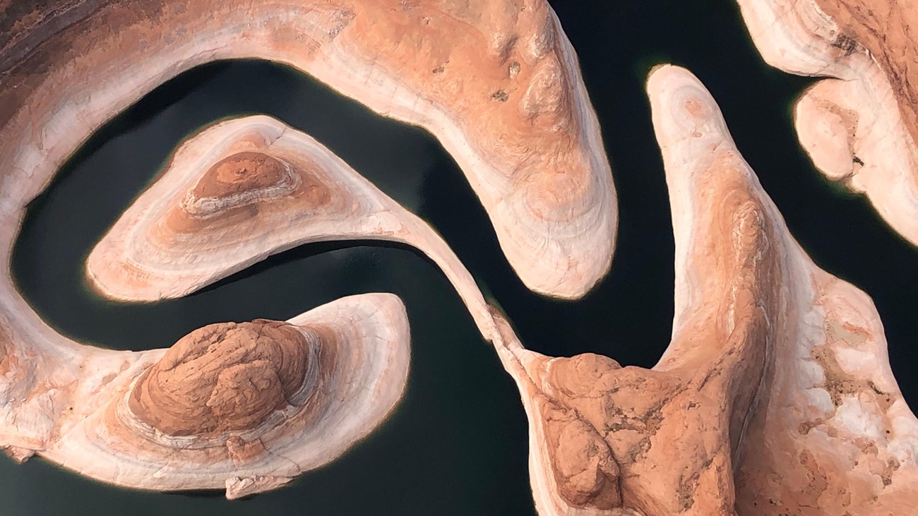 a river winds through red sandstone rock