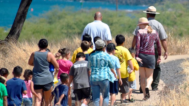 Park ranger leading group of kids along the trail