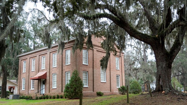 brick church with oak tree