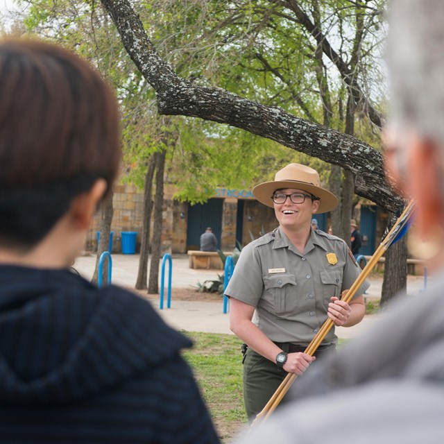 Park Ranger demonstrates the atl atl for a visiting field trip.