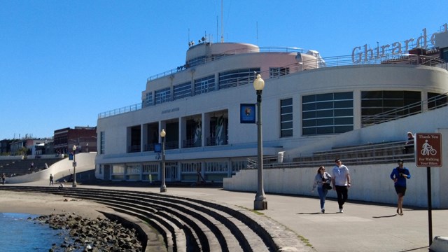 a white building designed to look like an ocean liner ship near a rocky shoreline