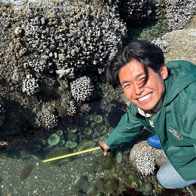 Intern pointing at water.