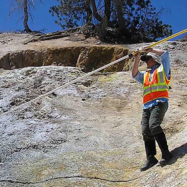 A scientist works in a volcanic area.