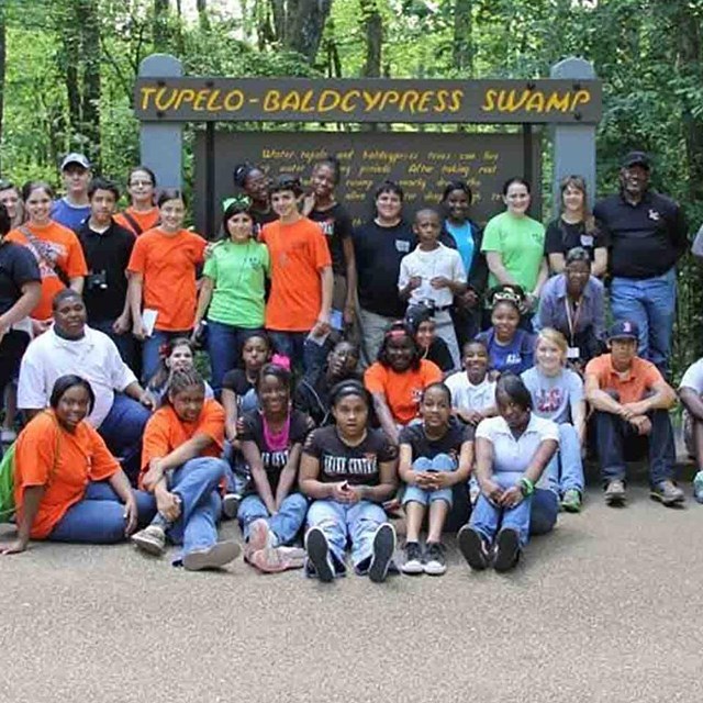 Volunteers stand in a group.